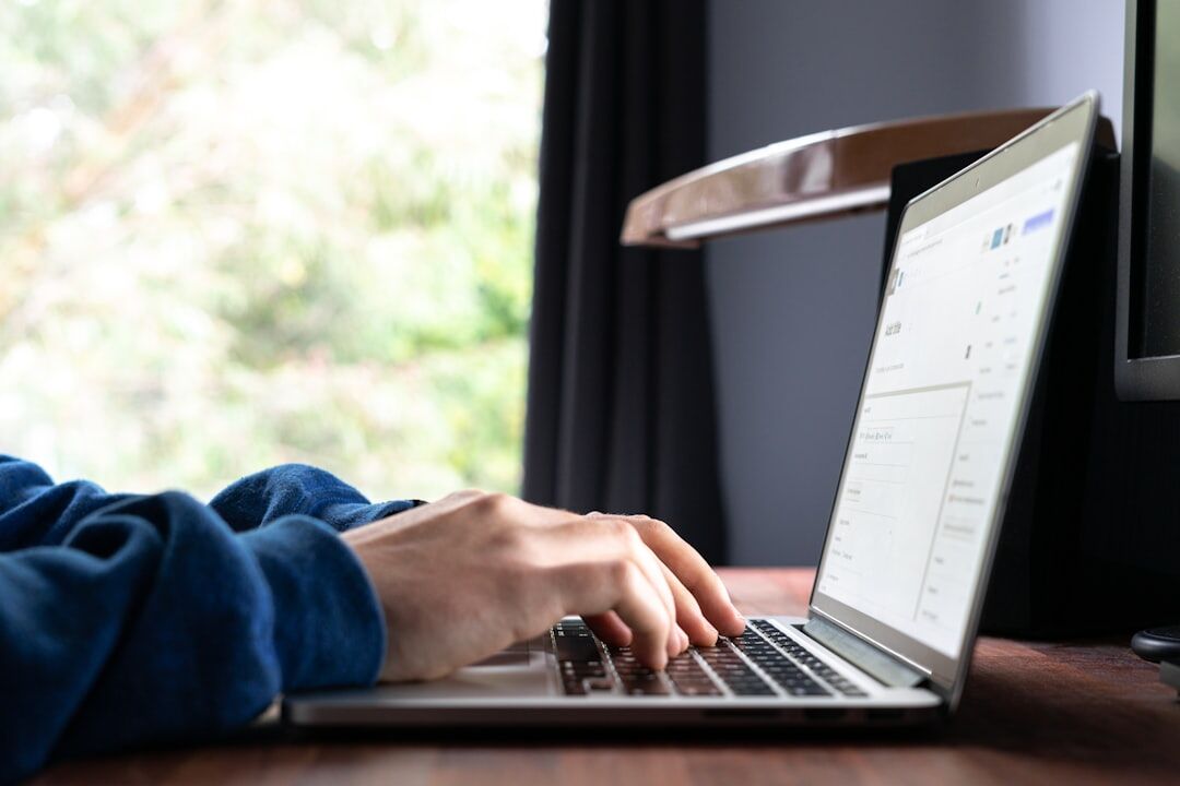 writer typing on laptop