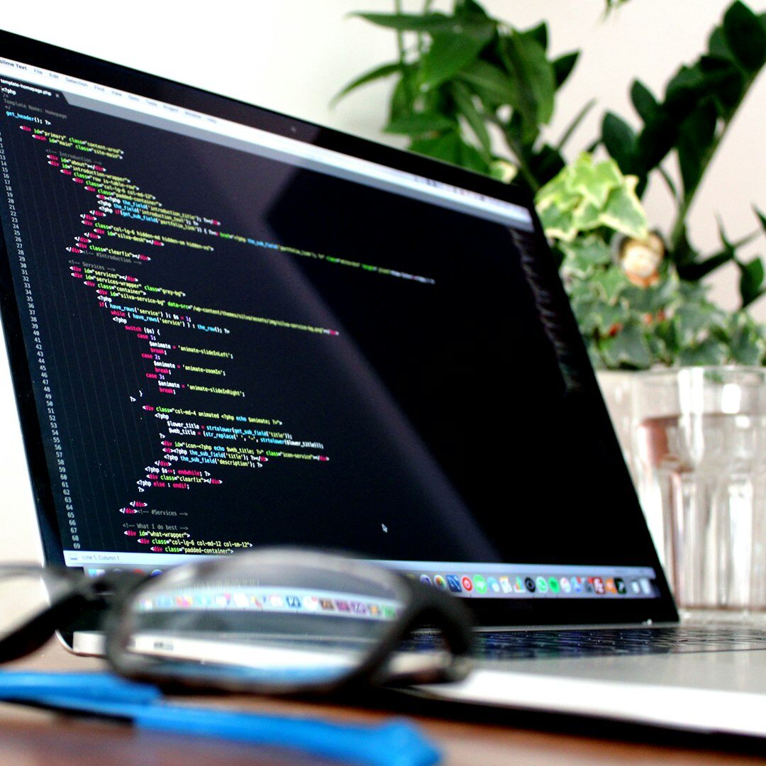 Small team of programmers reviewing code together